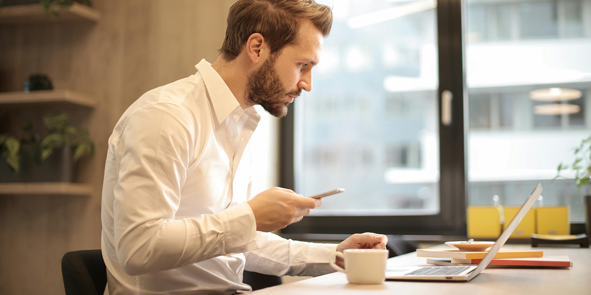 En man sitter vid ett skrivbord.